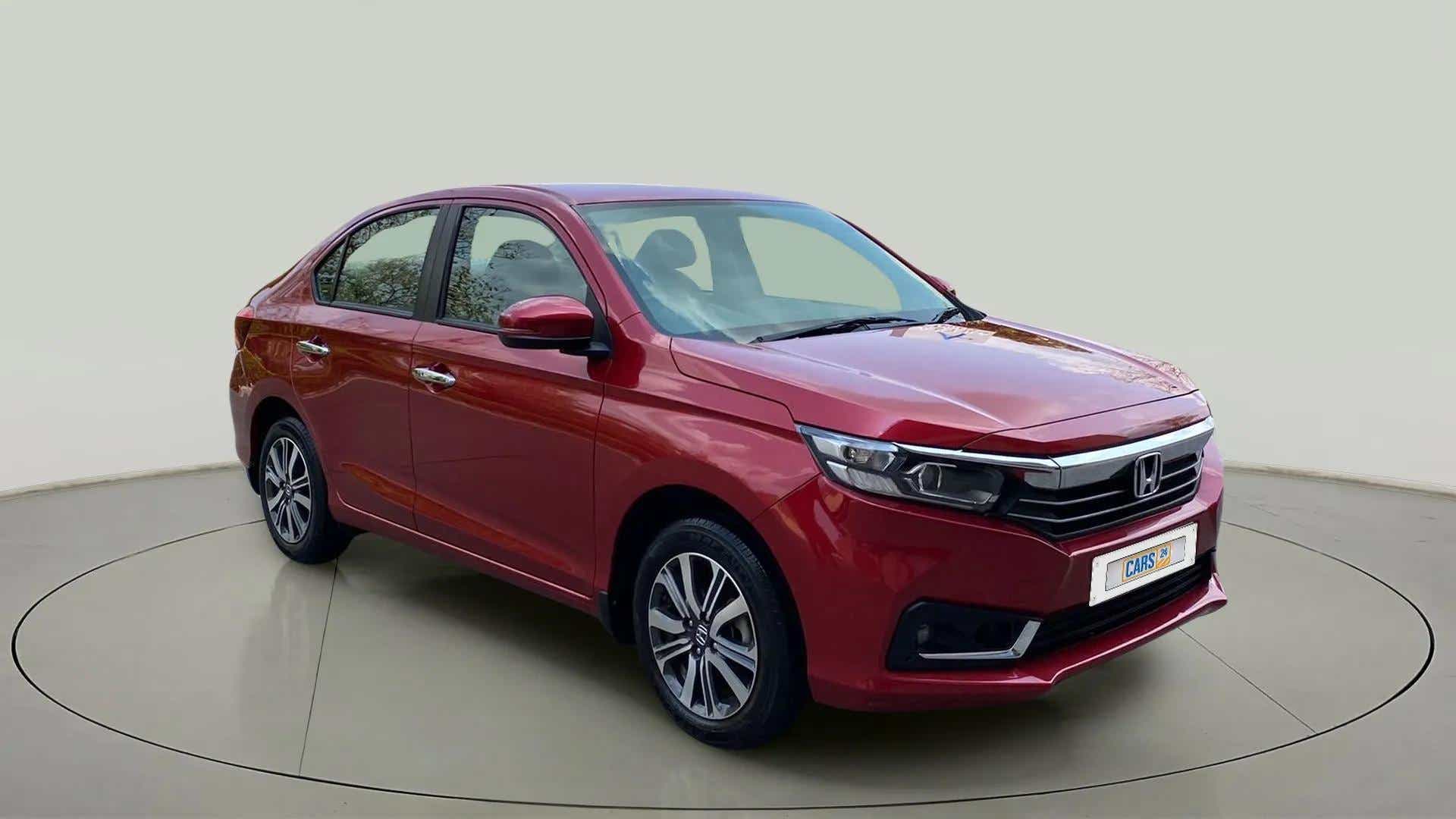 Front three-quarter view of a Radiant Red Metallic Honda Amaze