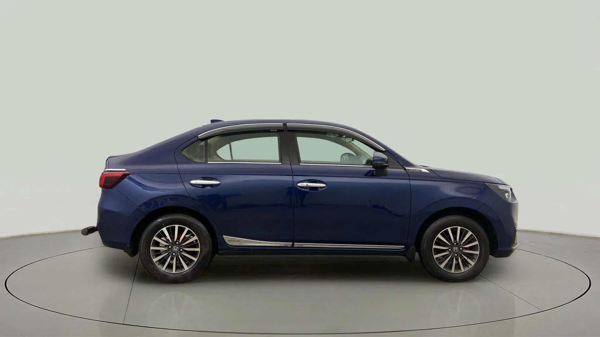 Side view of a obsidian blue pearl Honda Amaze