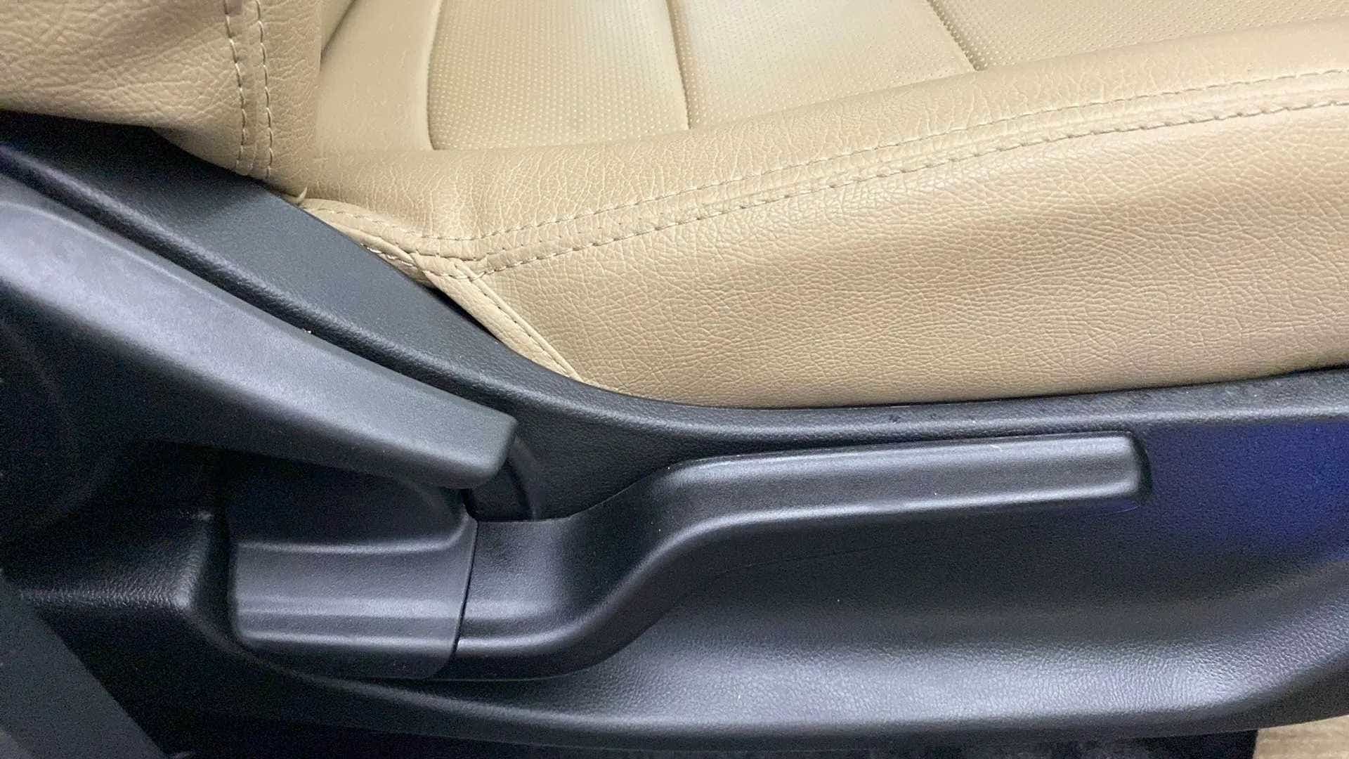 Close-up of a car seat adjustment lever in a Honda Amaze
