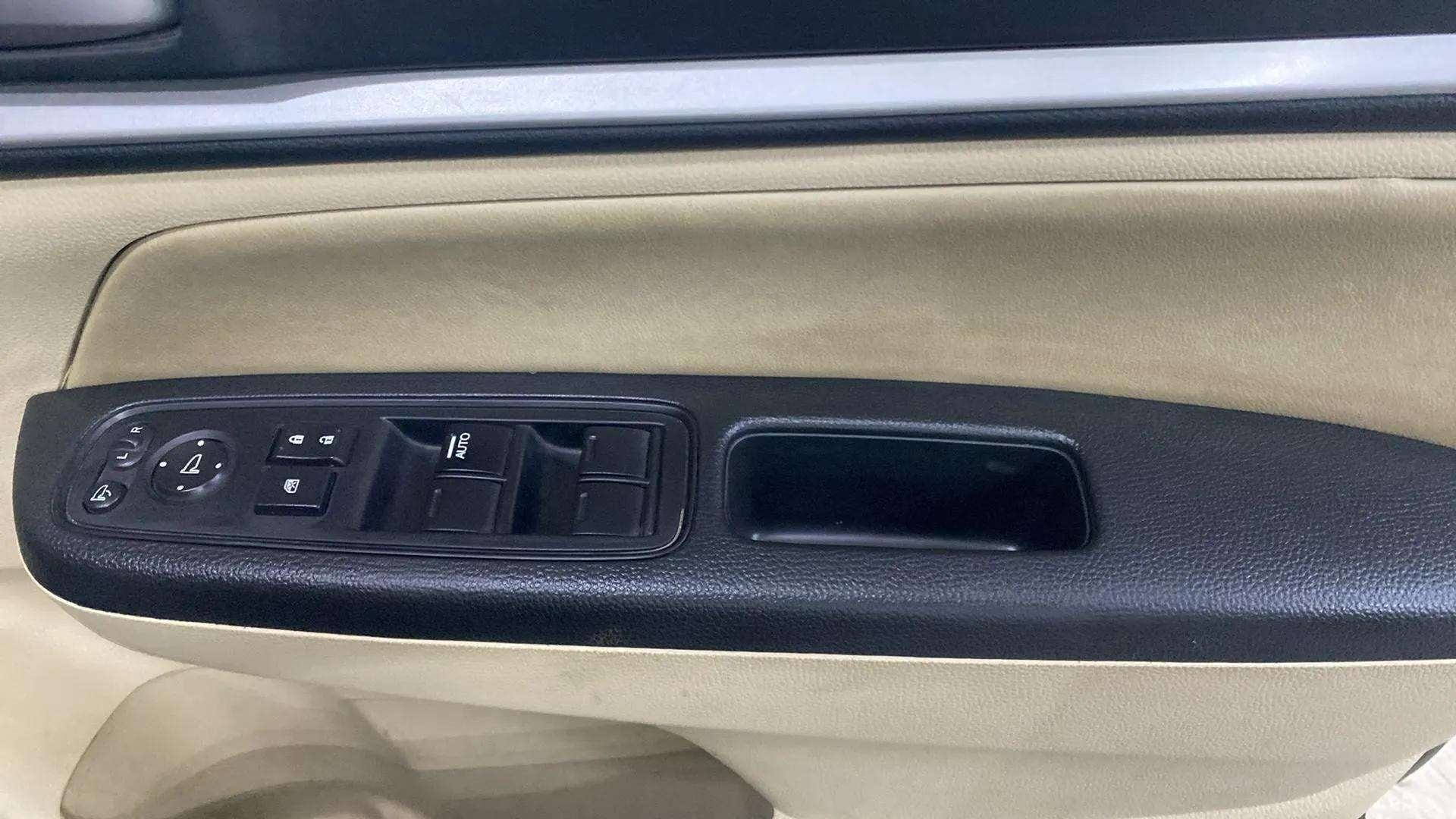 Interior driver-side door controls of a Honda Amaze