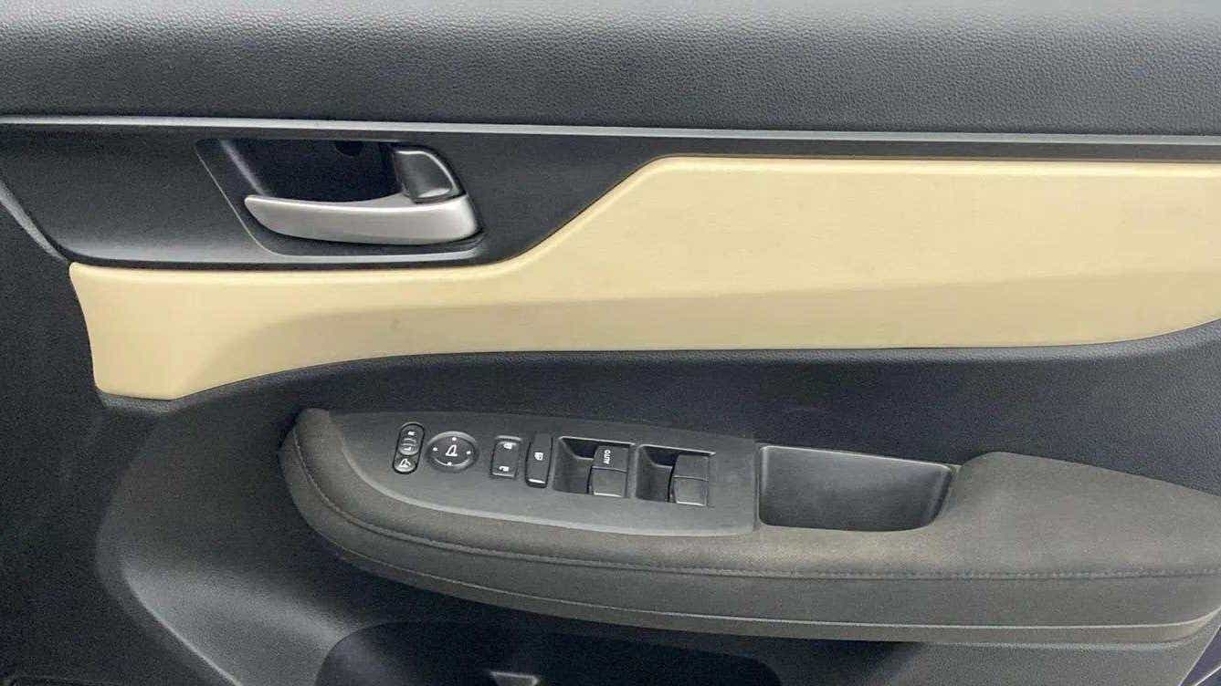 Front door panel and controls of a Honda Amaze