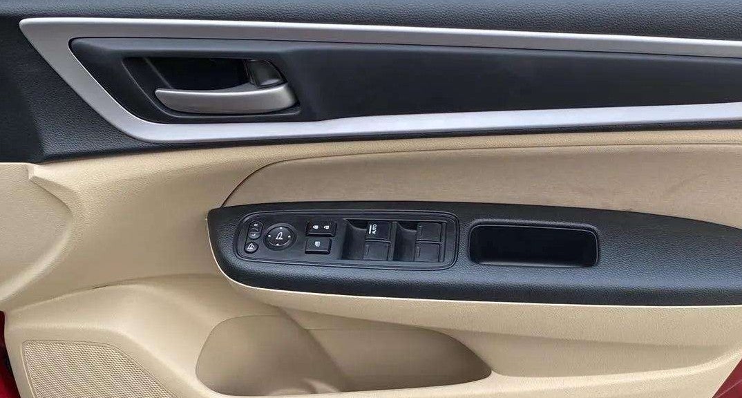 Front driver-side door panel controls of a Honda Amaze