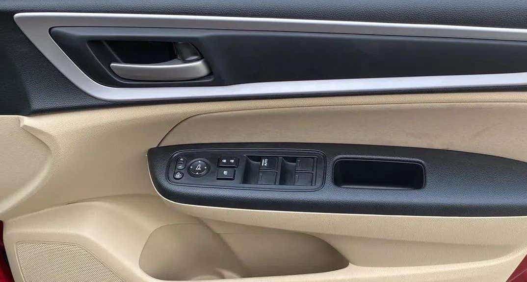 Front driver-side door panel controls of a Honda Amaze