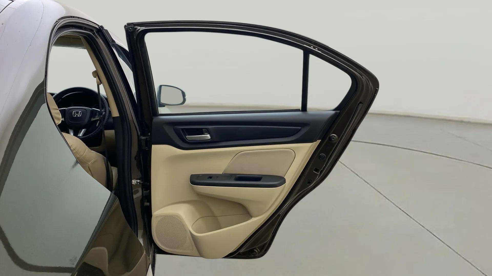 Rear door interior and partial front cabin of a Honda Amaze
