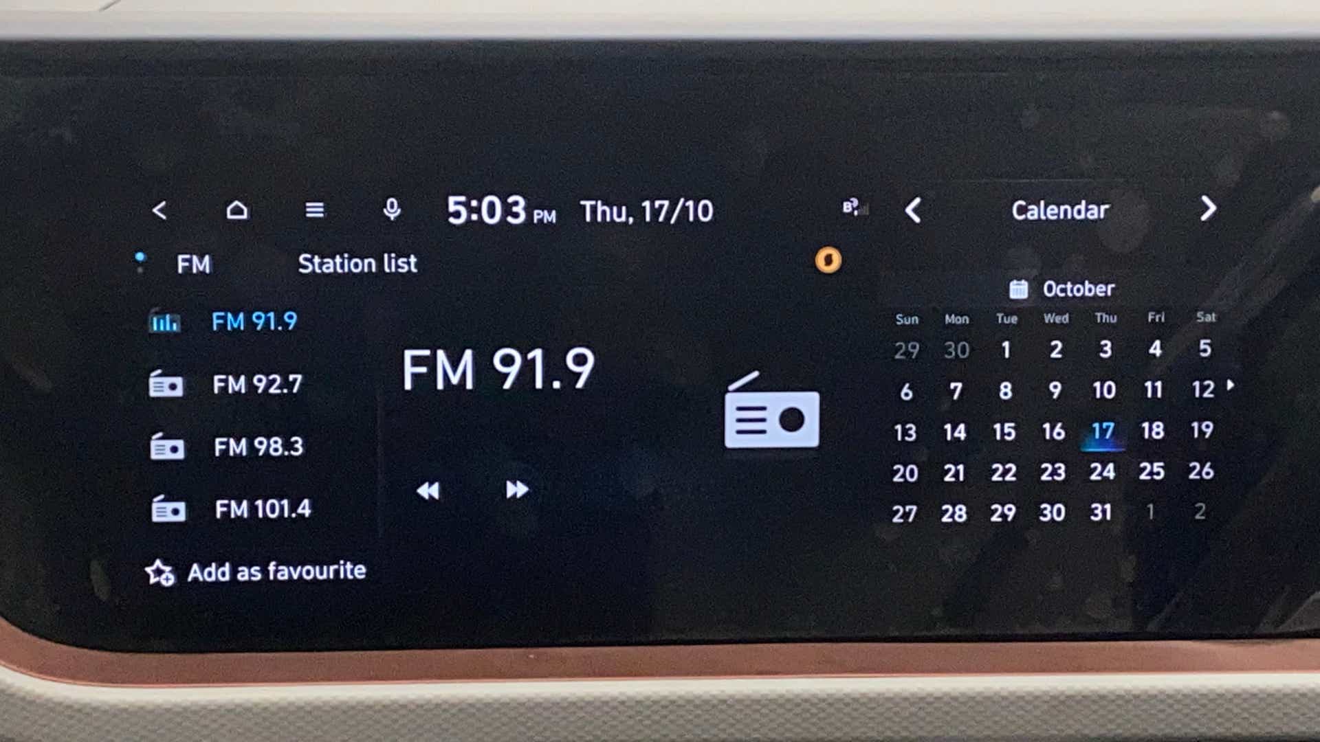 Car dashboard infotainment screen showing FM radio display of a Hyundai Creta