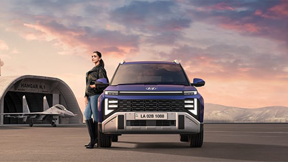 Front view of a Hyundai Venue Facelift with a person standing beside it