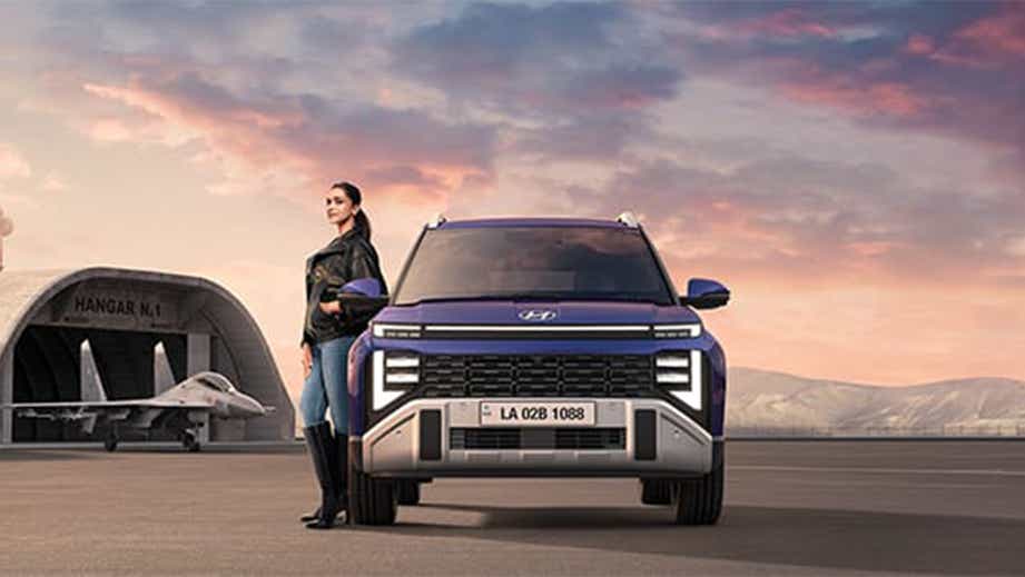 Front view of a Hyundai Venue Facelift with a person standing beside it