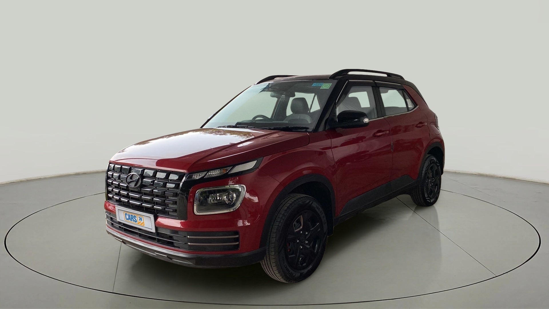 Front three-quarter view of a Fiery Red Hyundai Venue