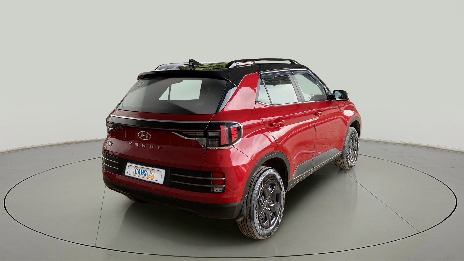Rear three-quarter of a Fiery Red With Abyss Black Hyundai Venue