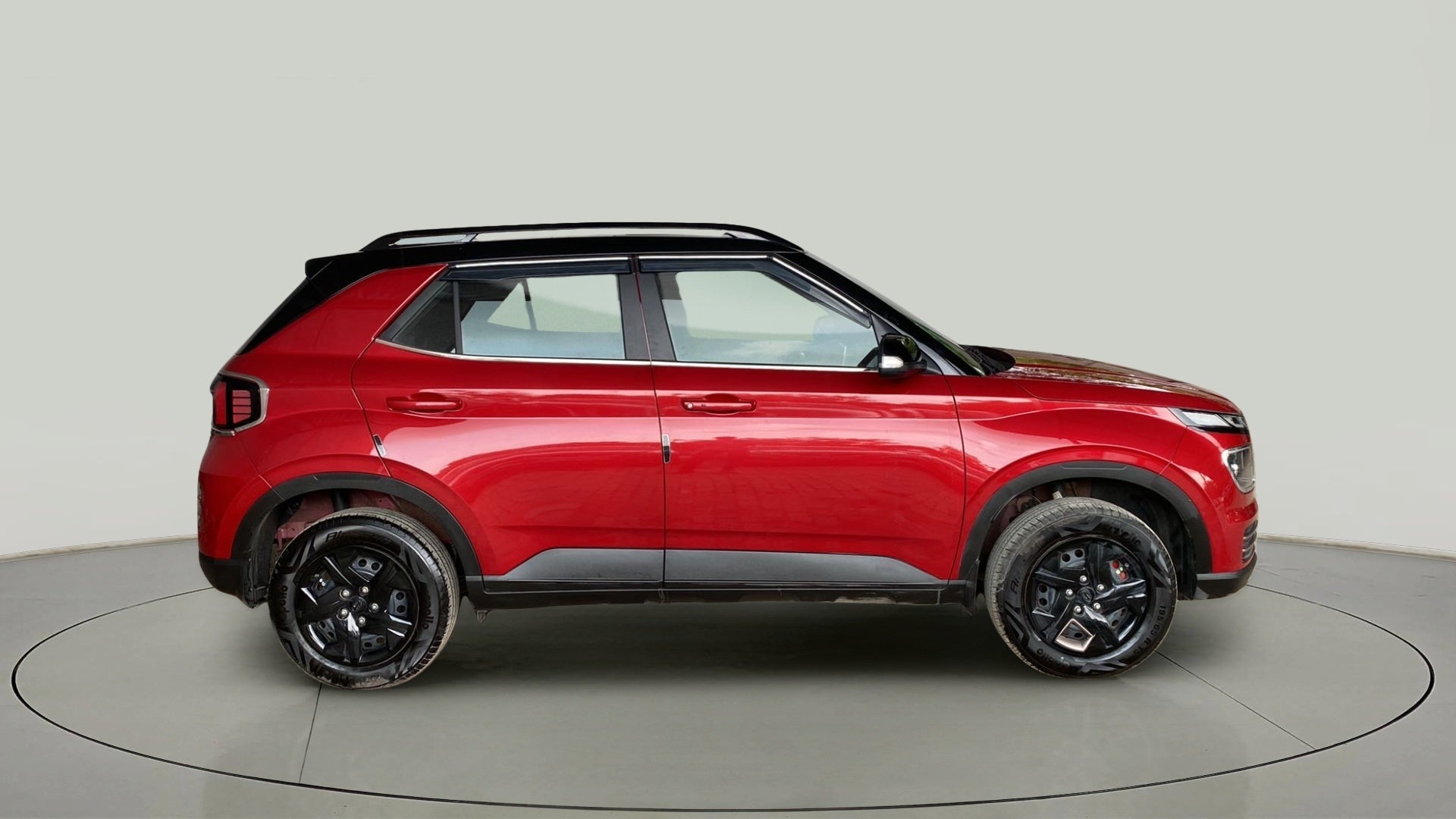 Side view of a Fiery Red With Abyss Black Hyundai Venue