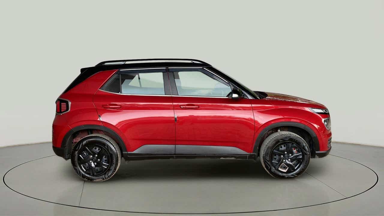 Side view of a Fiery Red With Abyss Black Hyundai Venue