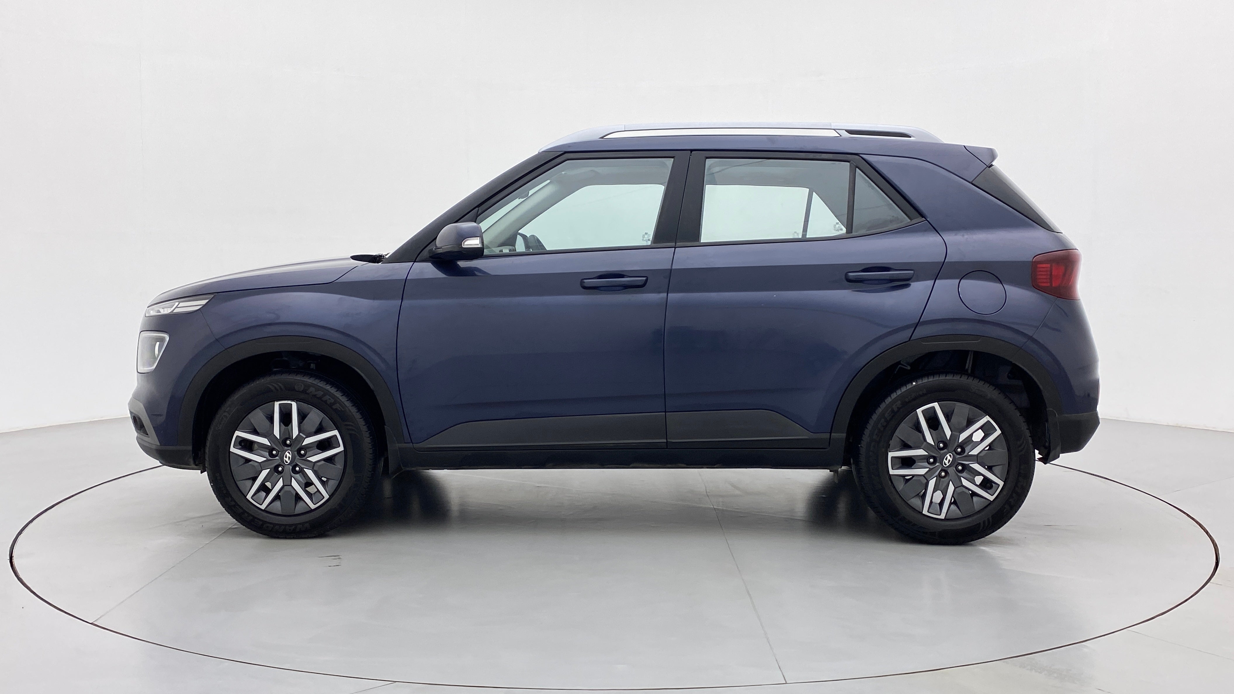 Side view of a denim blue Hyundai Venue