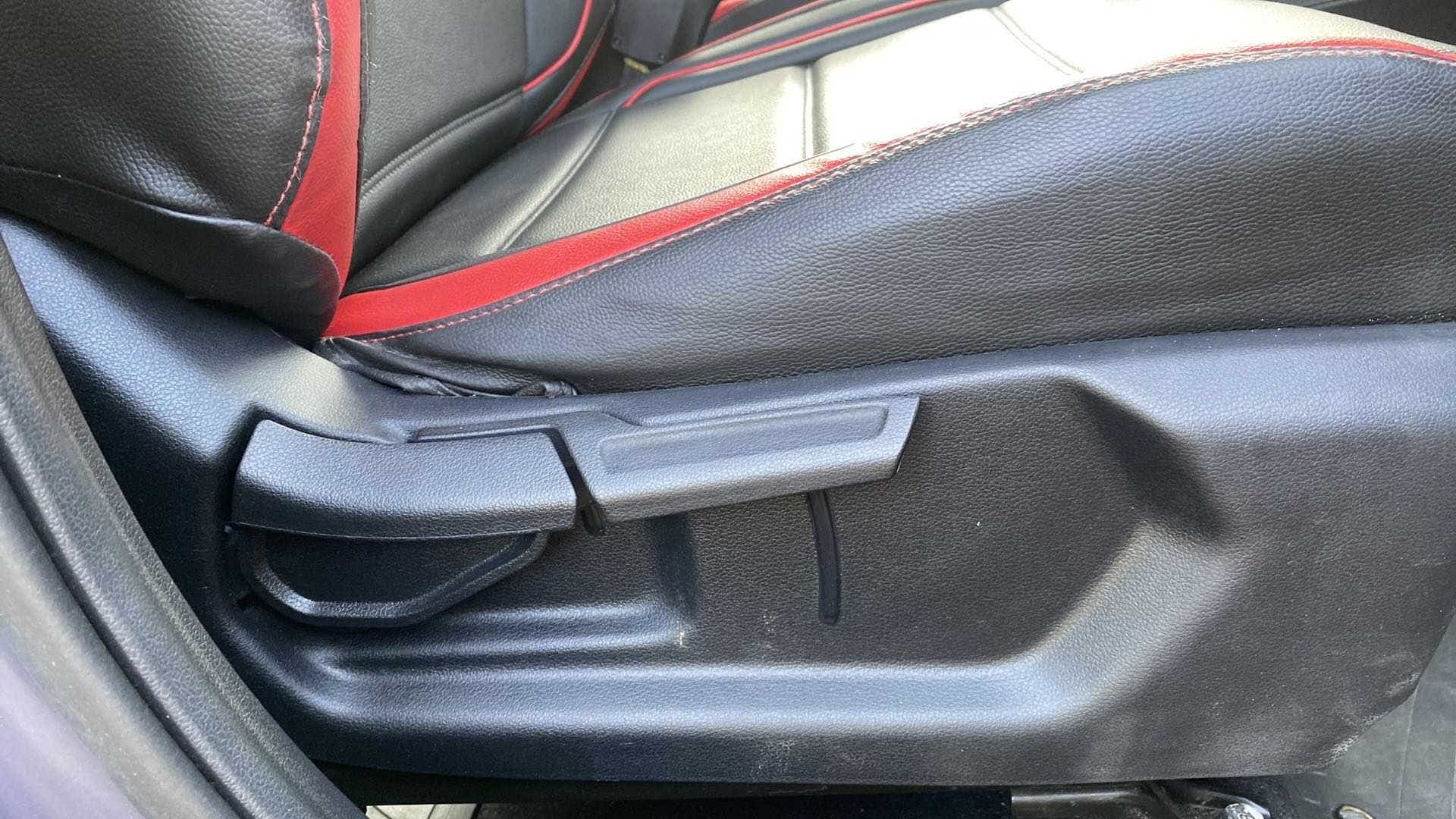 Car seat adjustment lever and side view of a Hyundai Venue seat