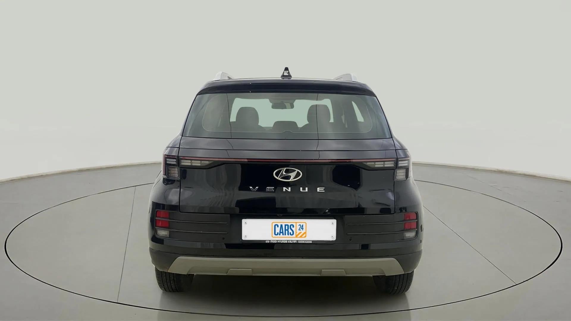 Rear view of a abyss black Hyundai Venue
