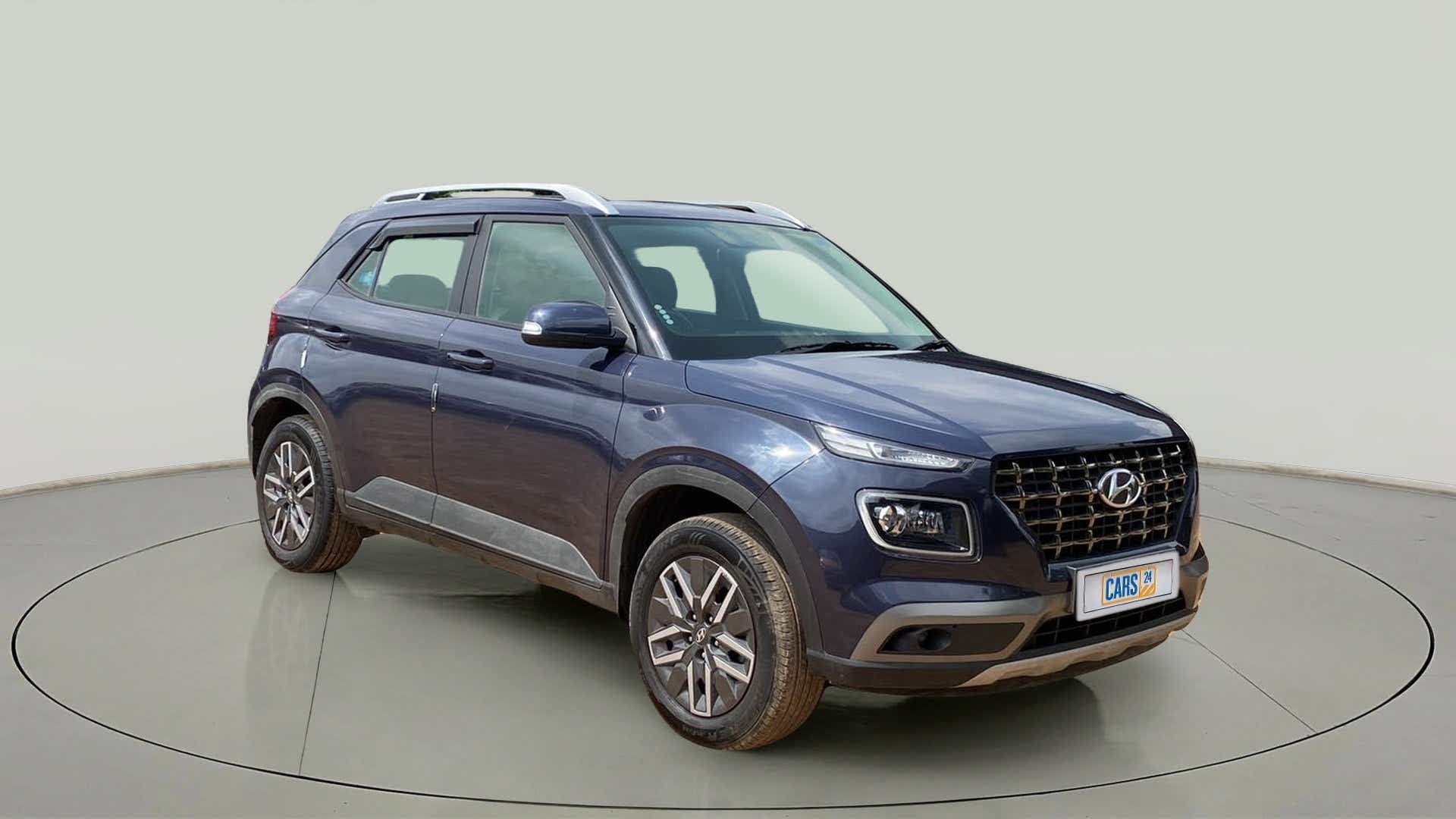 Front three-quarter view of a denim blue Hyundai Venue