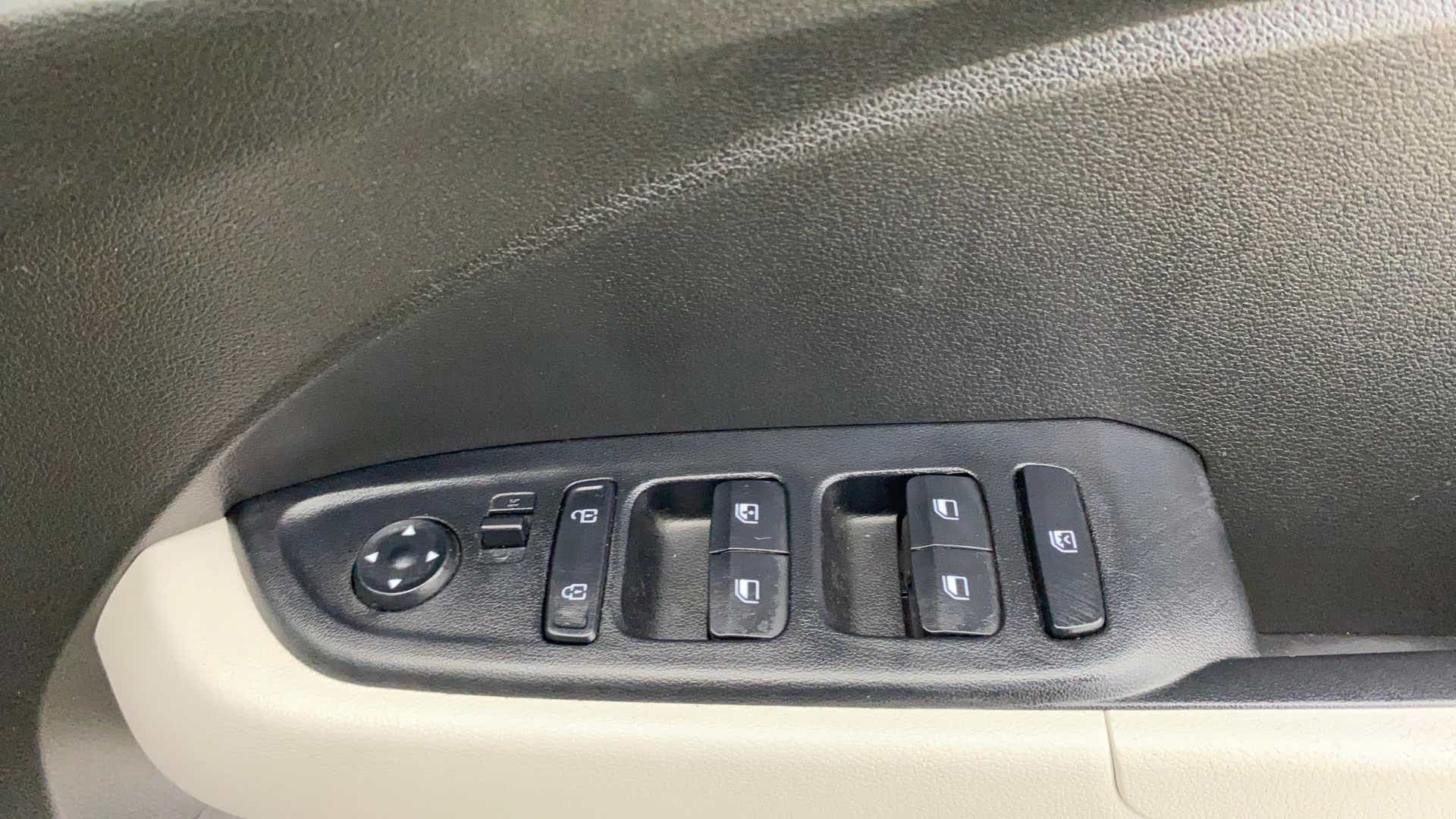 Driver side window and mirror controls of a Hyundai Venue