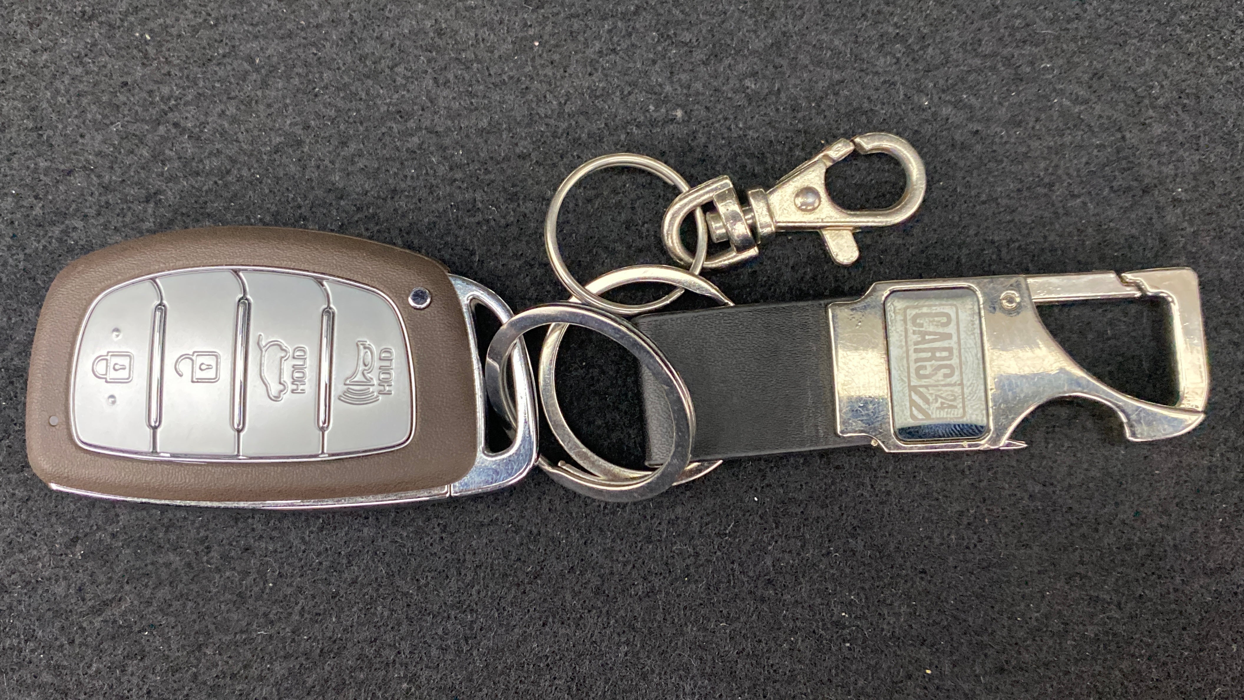 Close-up of a Hyundai Venue key fob with holder attachment