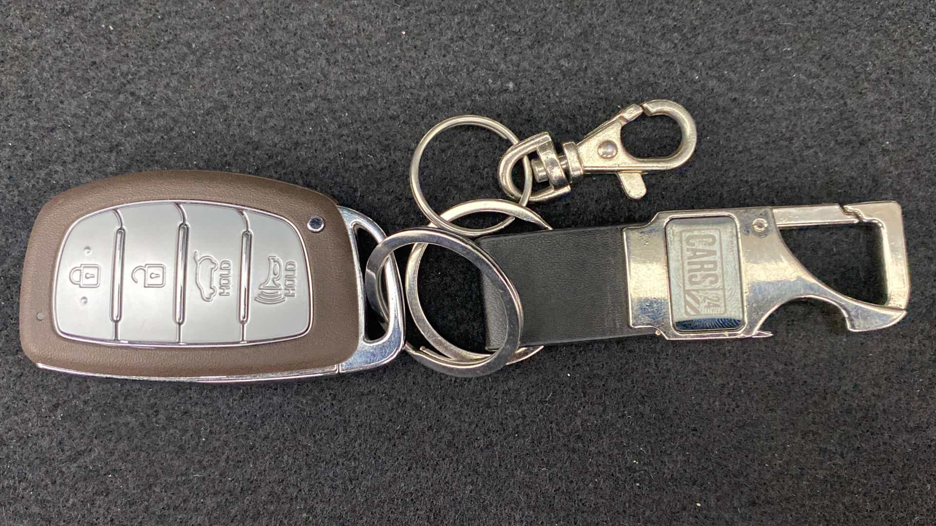 Close-up of a Hyundai Venue key fob with holder attachment