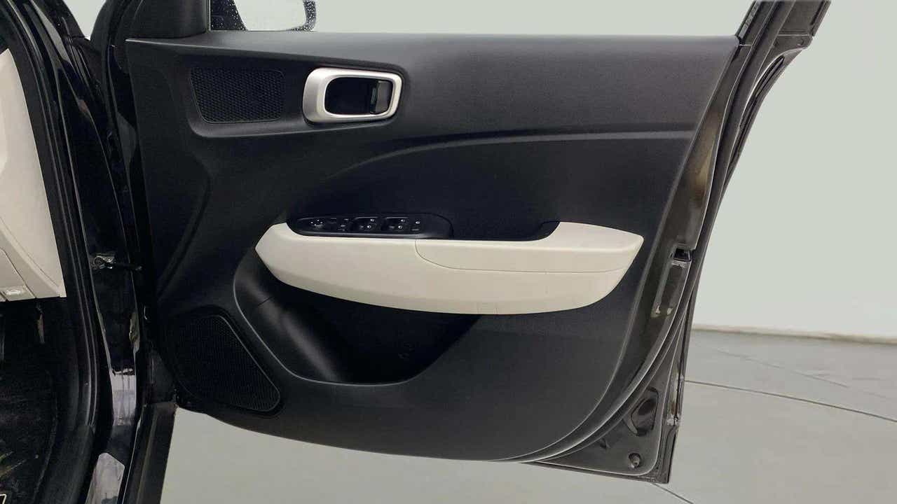 Interior driver-side door panel of a Hyundai Venue