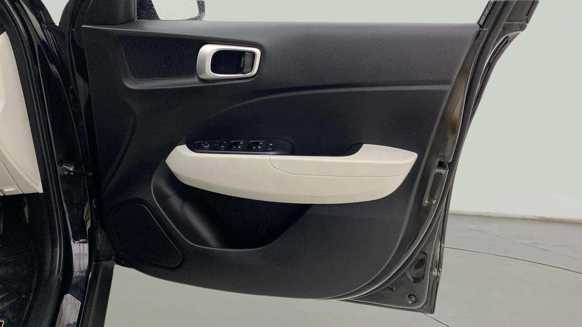 Interior driver-side door panel of a Hyundai Venue