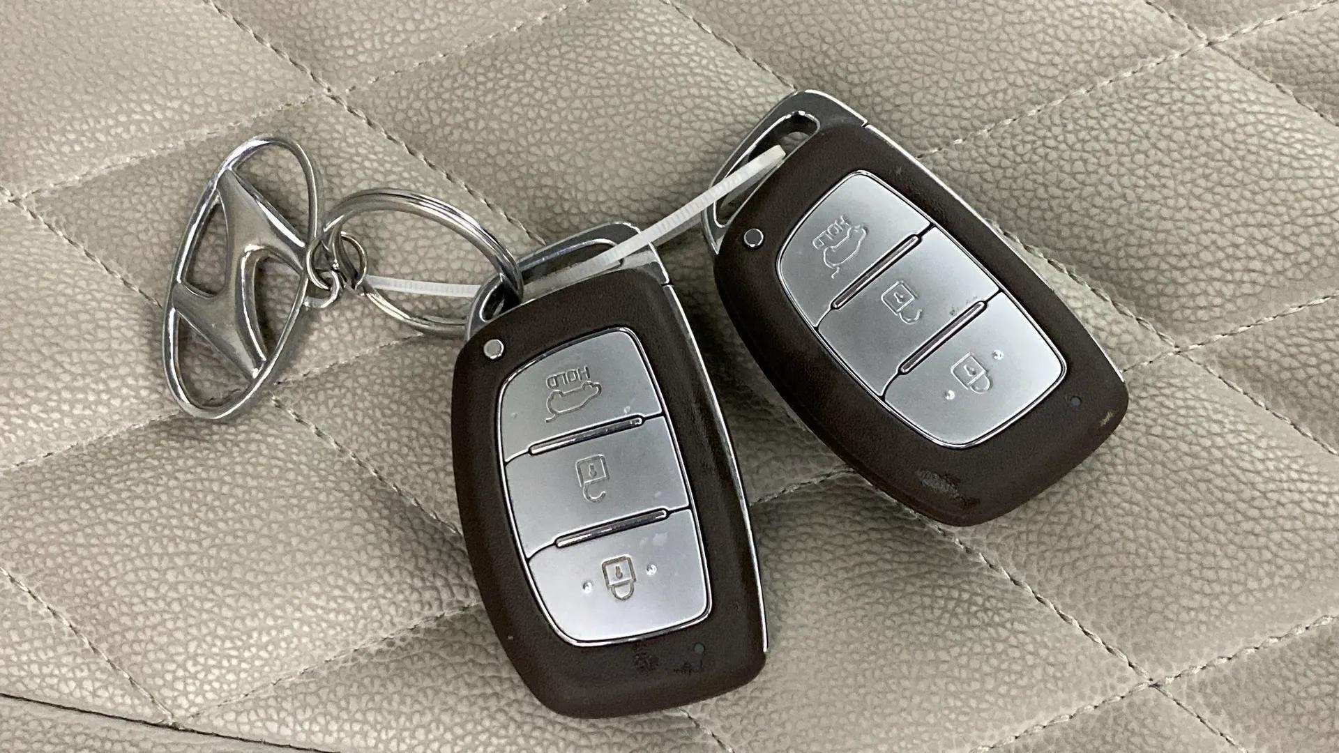 Car key fobs of a Hyundai Venue on seat upholstery