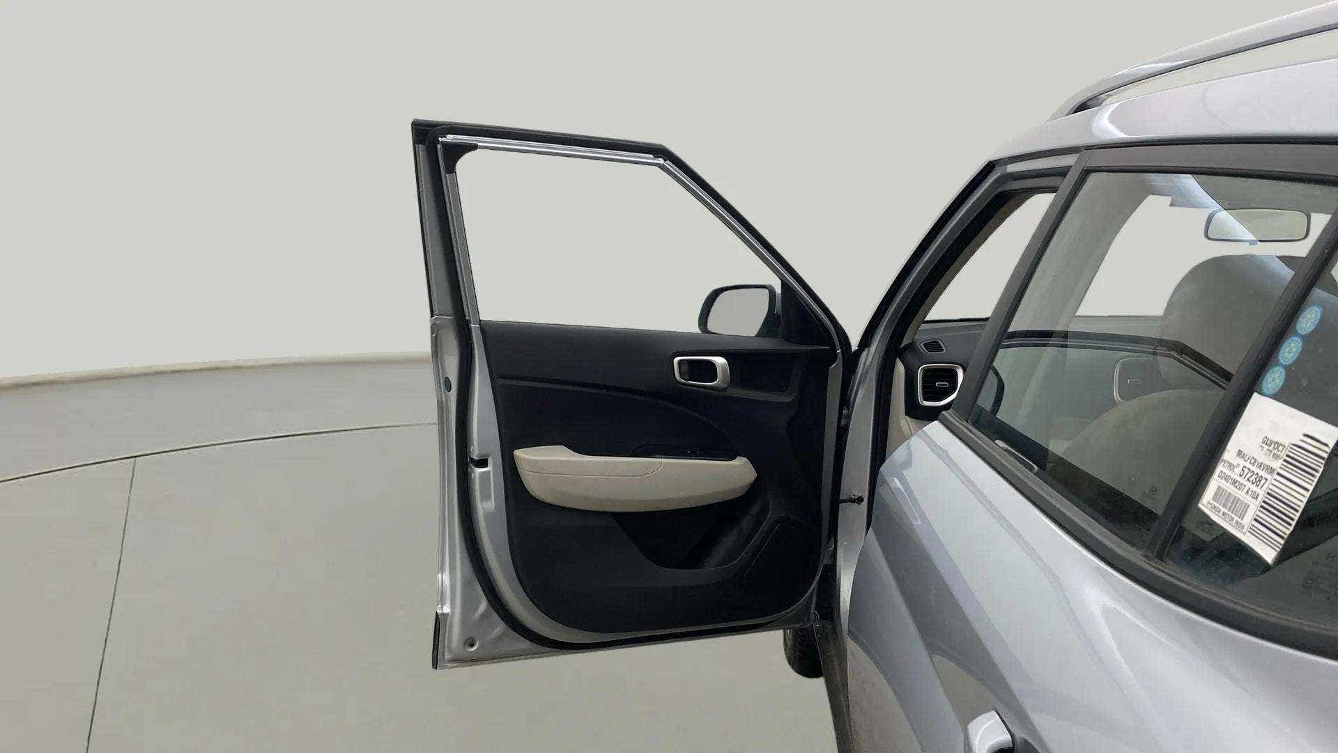 Open front left door view of a Hyundai Venue