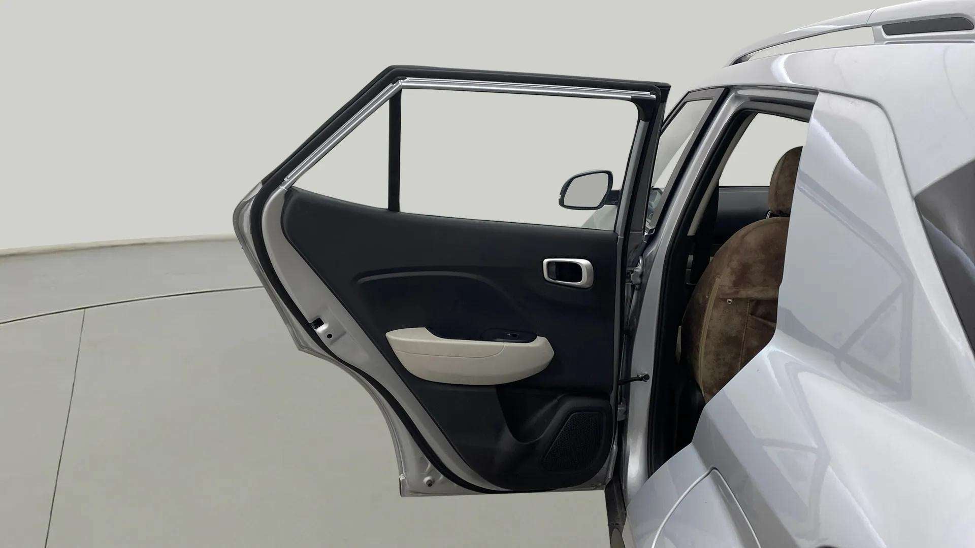 Rear left door open view of a Hyundai Venue