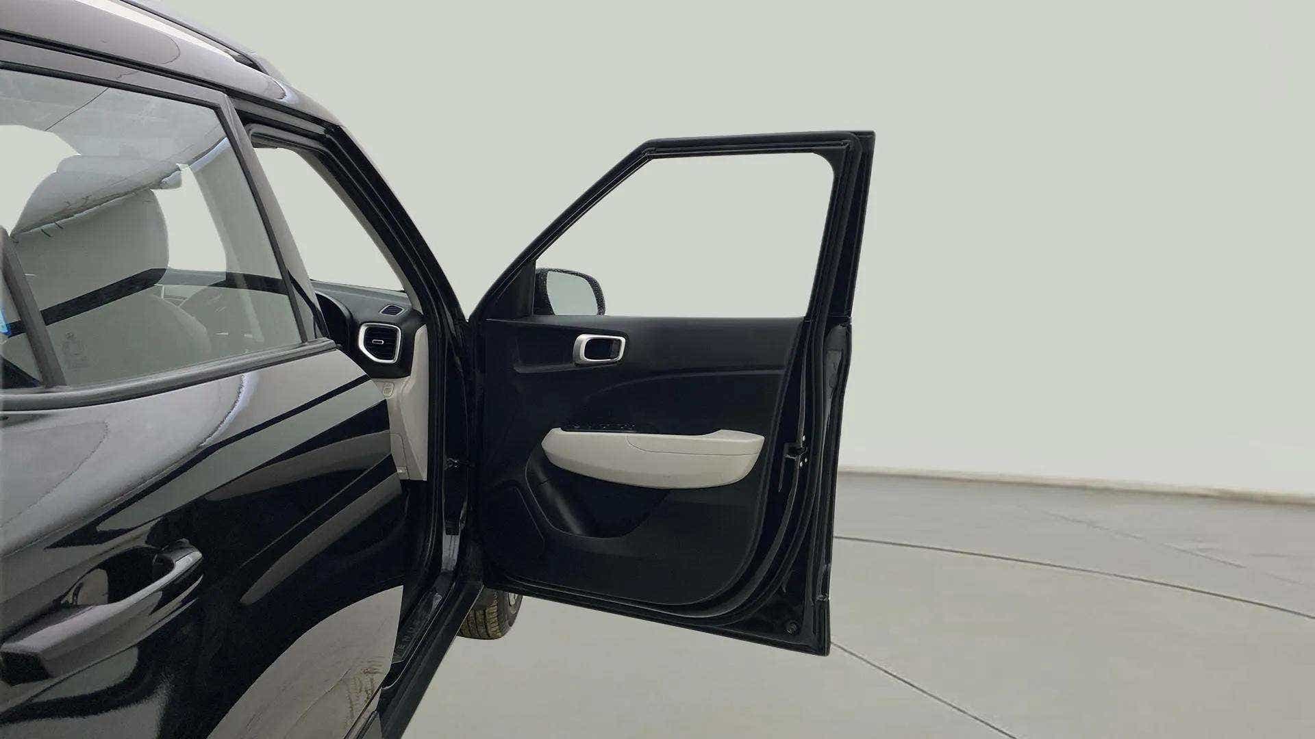 Front driver side door open view of a Hyundai Venue