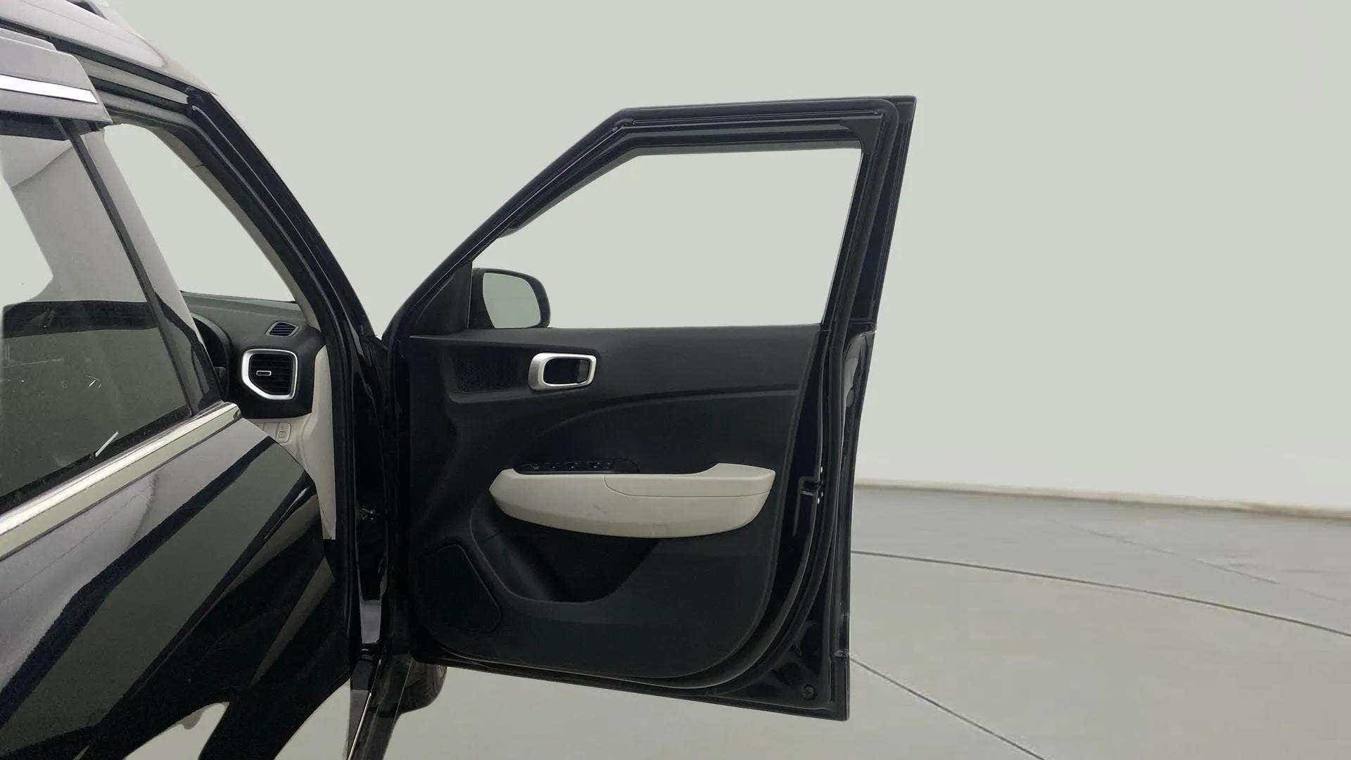 Front driver side door open view of a Hyundai Venue