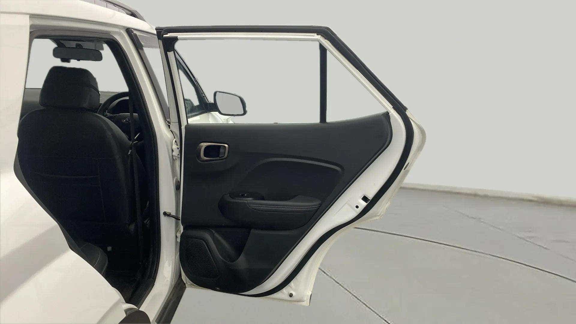 Rear left door open view of a Hyundai Venue