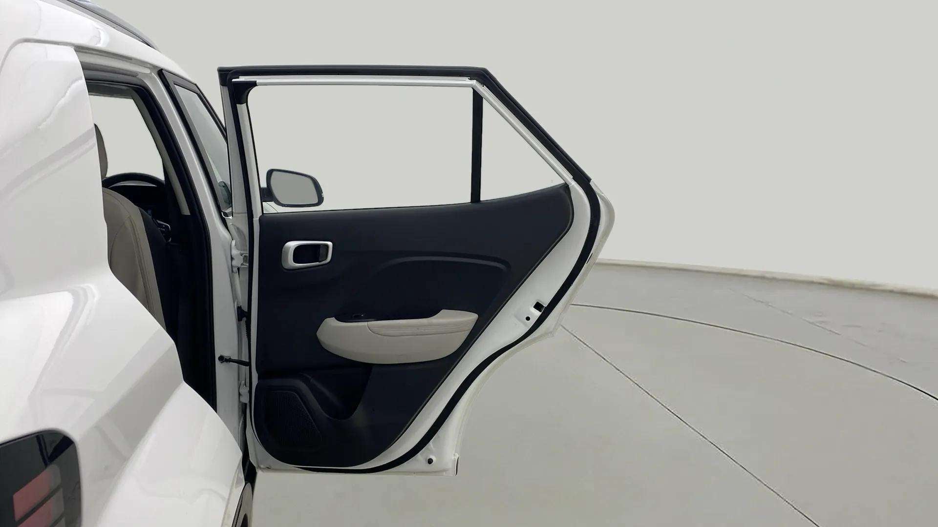 Rear left door open view of a Hyundai Venue