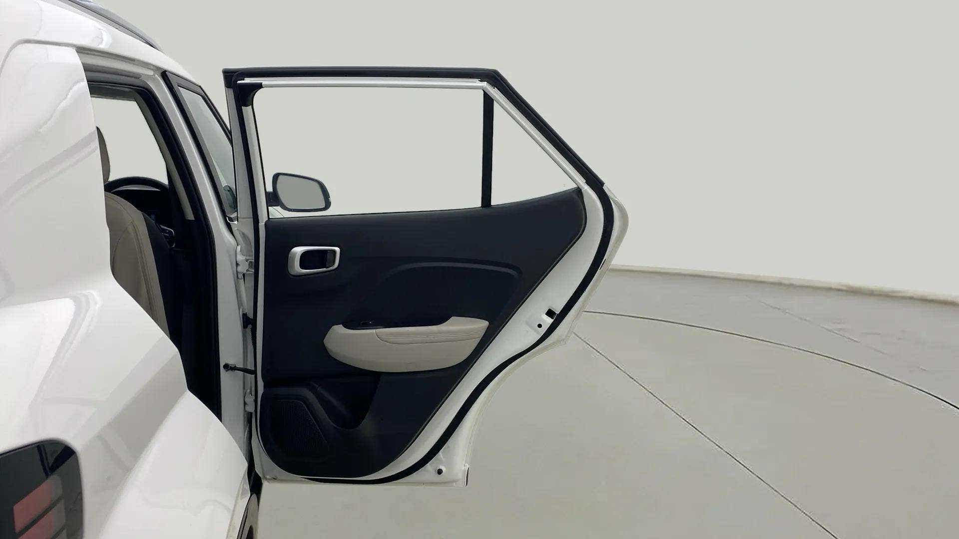 Rear left door open view of a Hyundai Venue