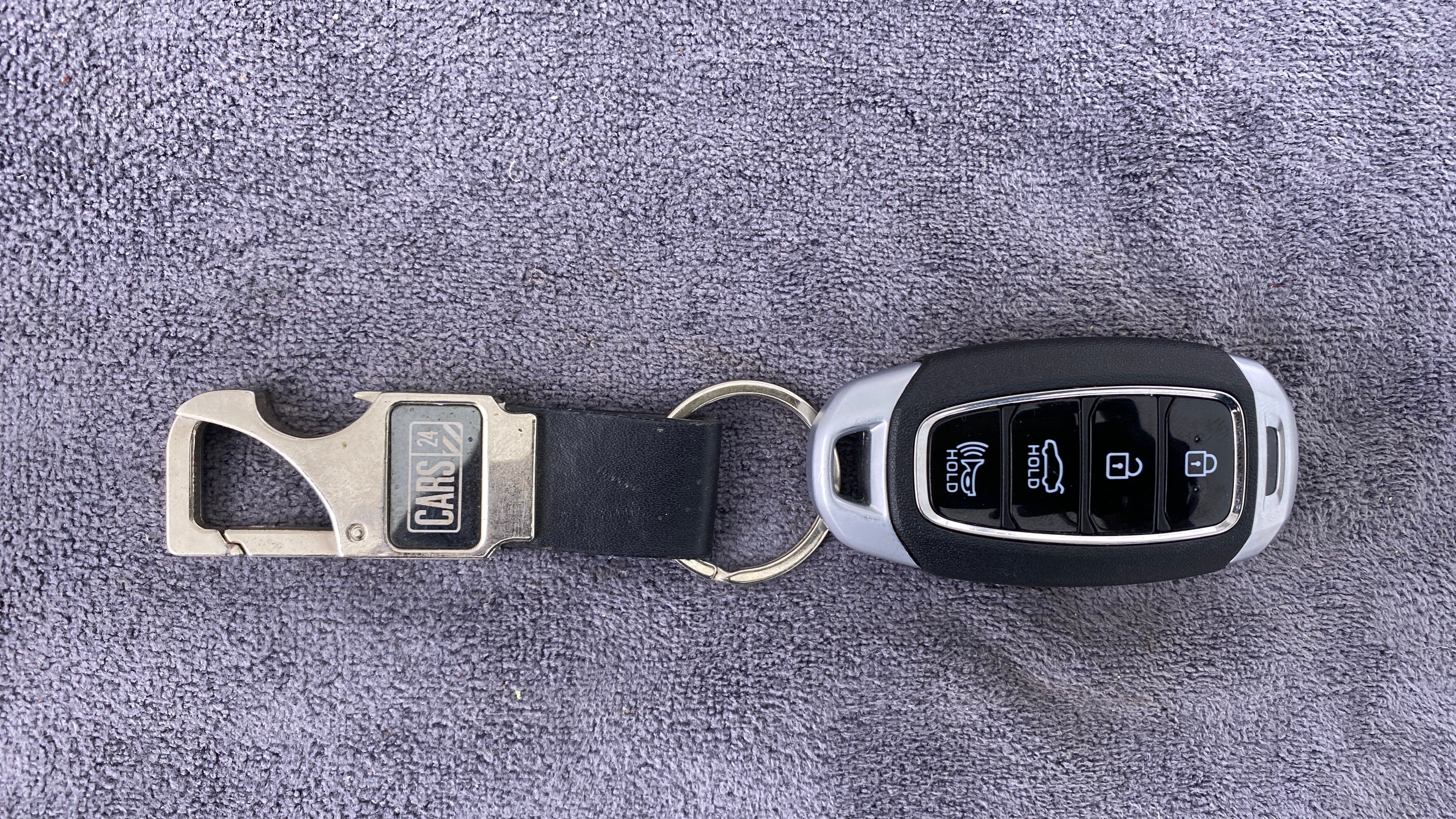 Top view of a Hyundai Verna key fob with keychain