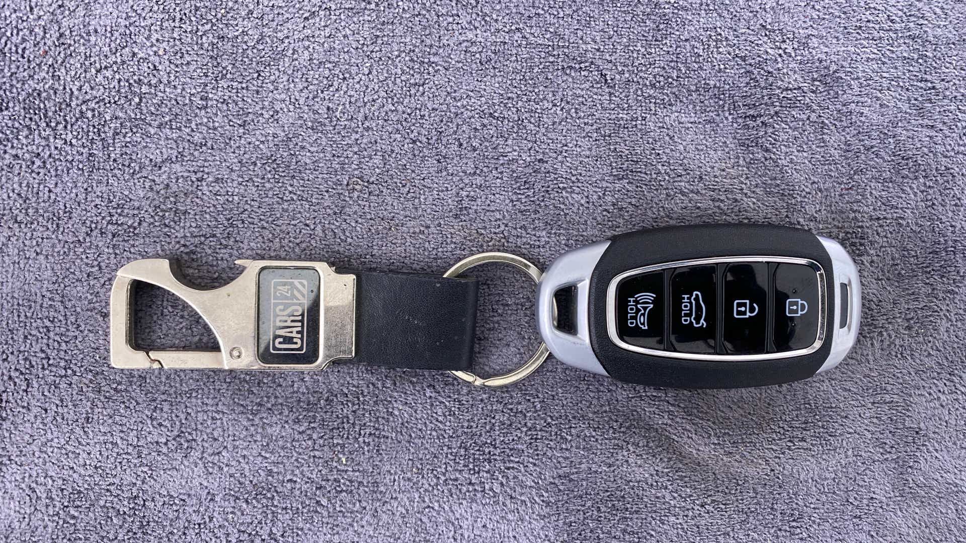 Top view of a Hyundai Verna key fob with keychain
