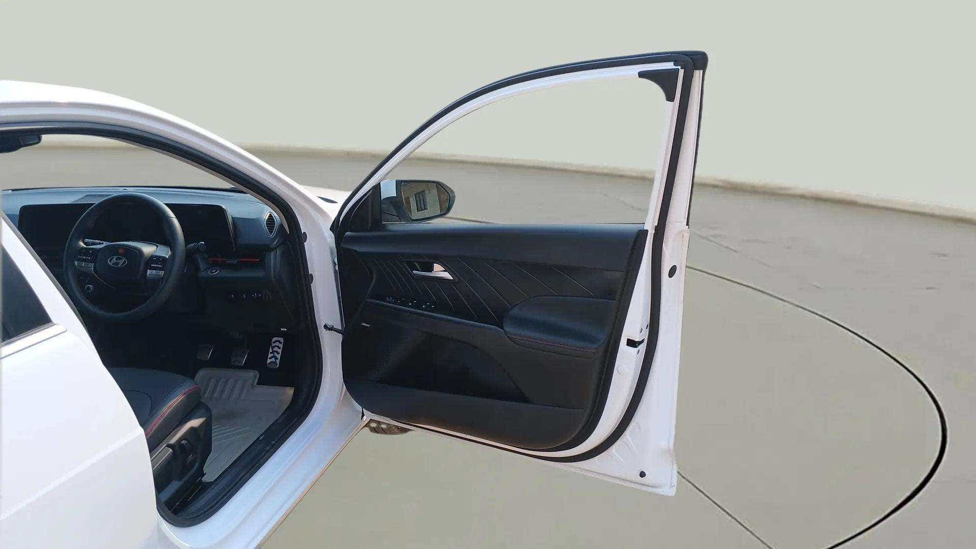 Front driver side open door and dashboard of a Hyundai Verna