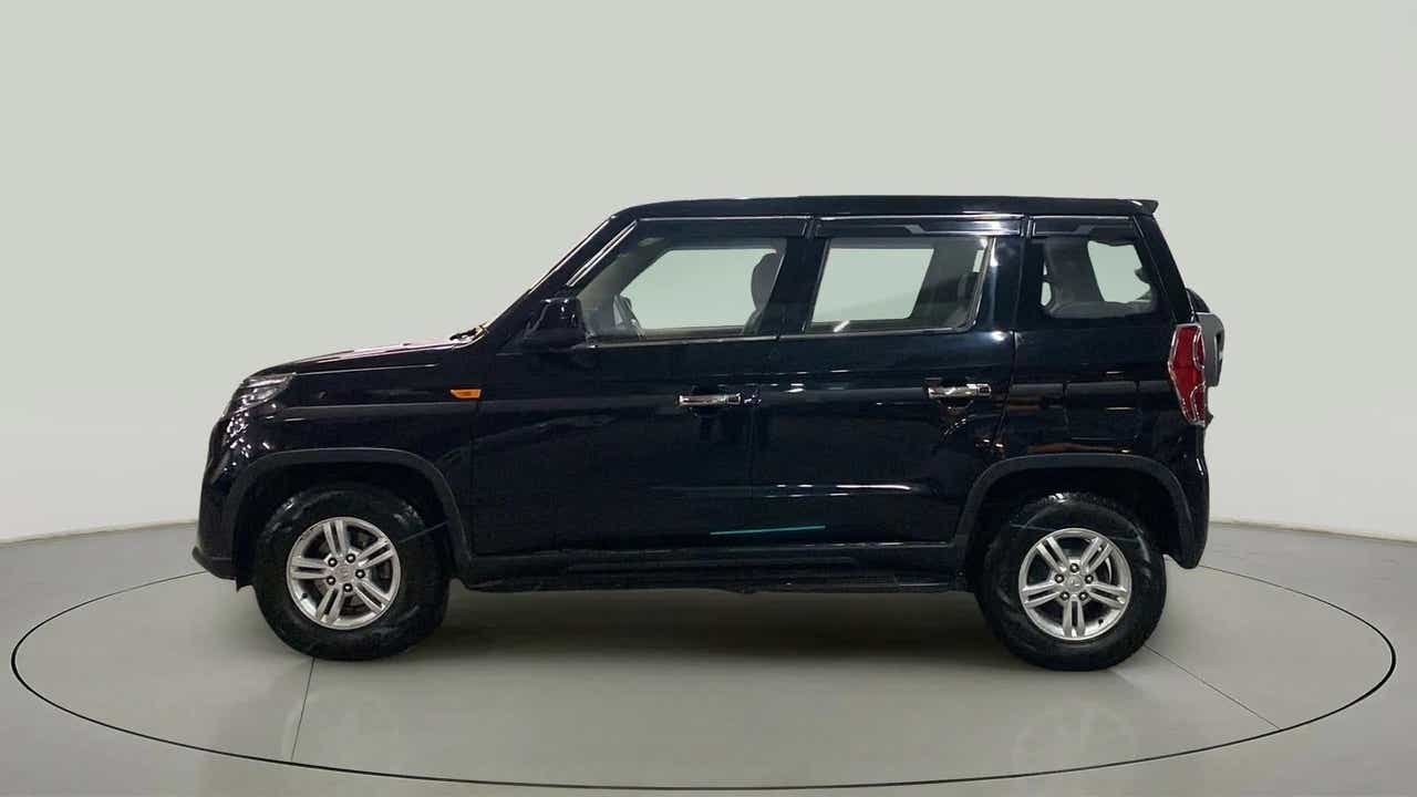 Side profile of a Stealth Black Mahindra Bolero Neo