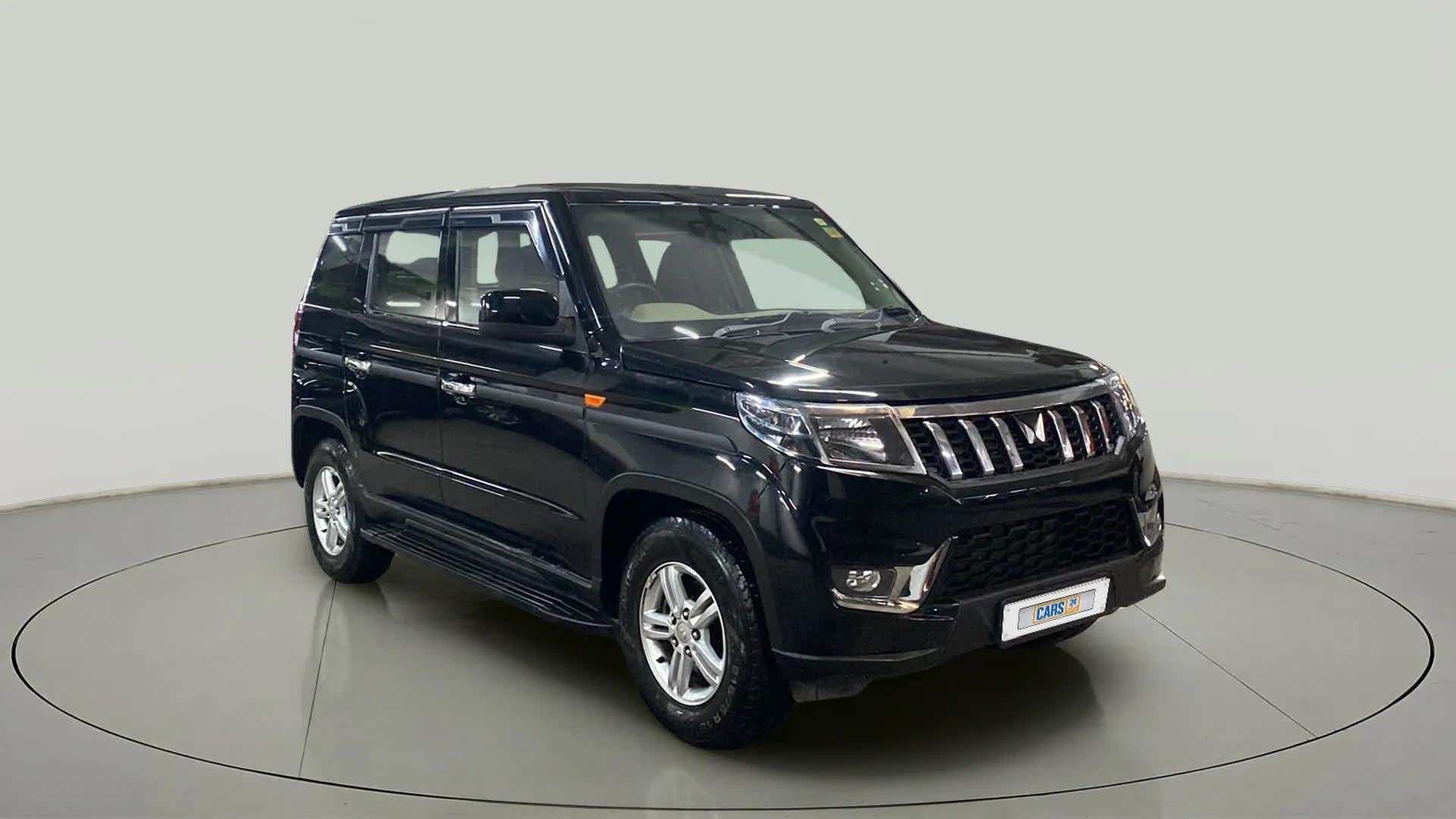 Front three-quarter view of a stealth black Mahindra Bolero Neo