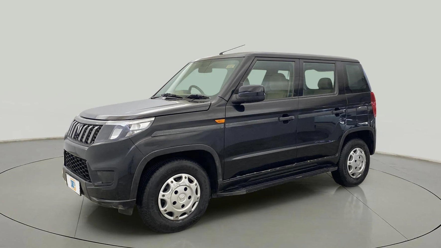 Front and side view of a Mahindra Bolero Neo