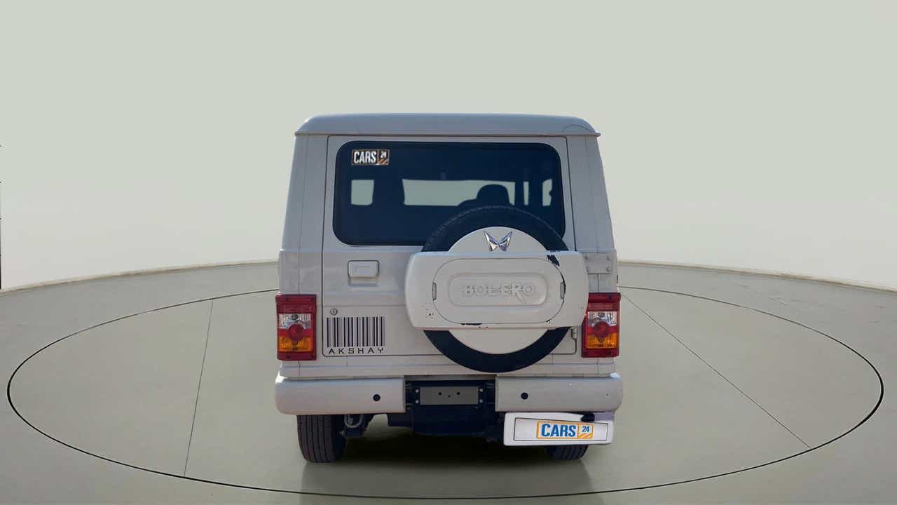 Rear view of a diamond white Mahindra Bolero