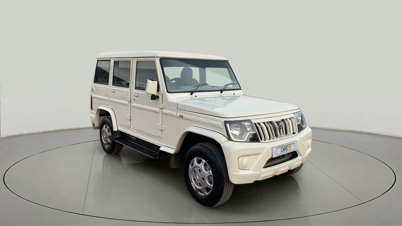 Front three-quarter view of a diamond white Mahindra Bolero