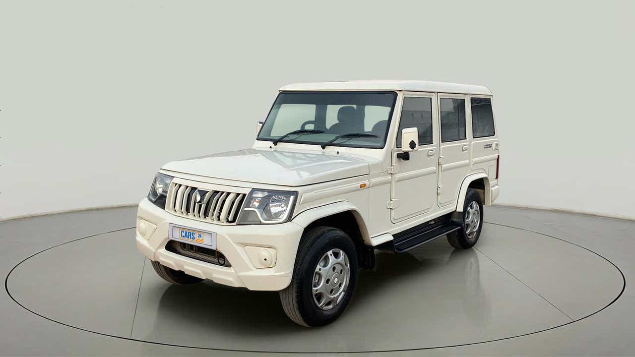Front three-quarter view of a diamond white Mahindra Bolero