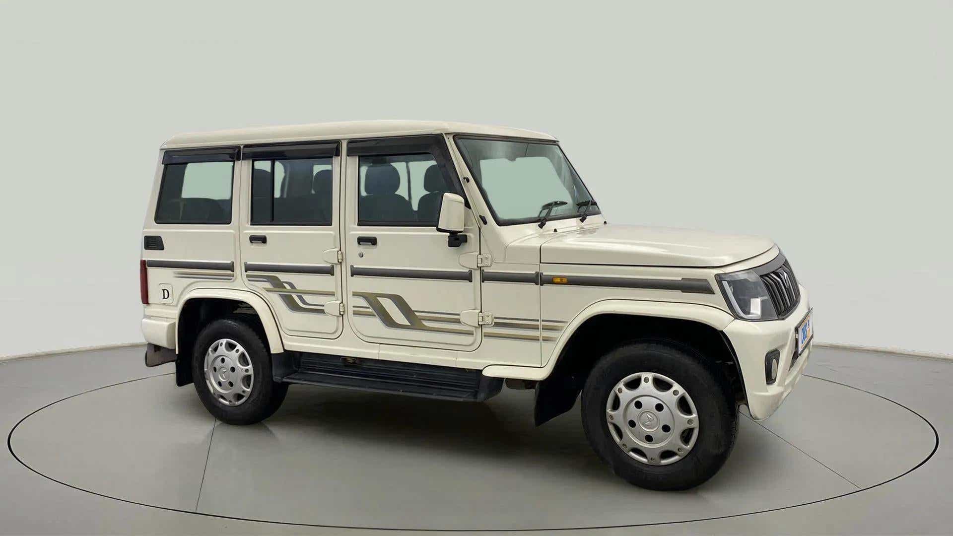 Side view of a diamond white Mahindra Bolero