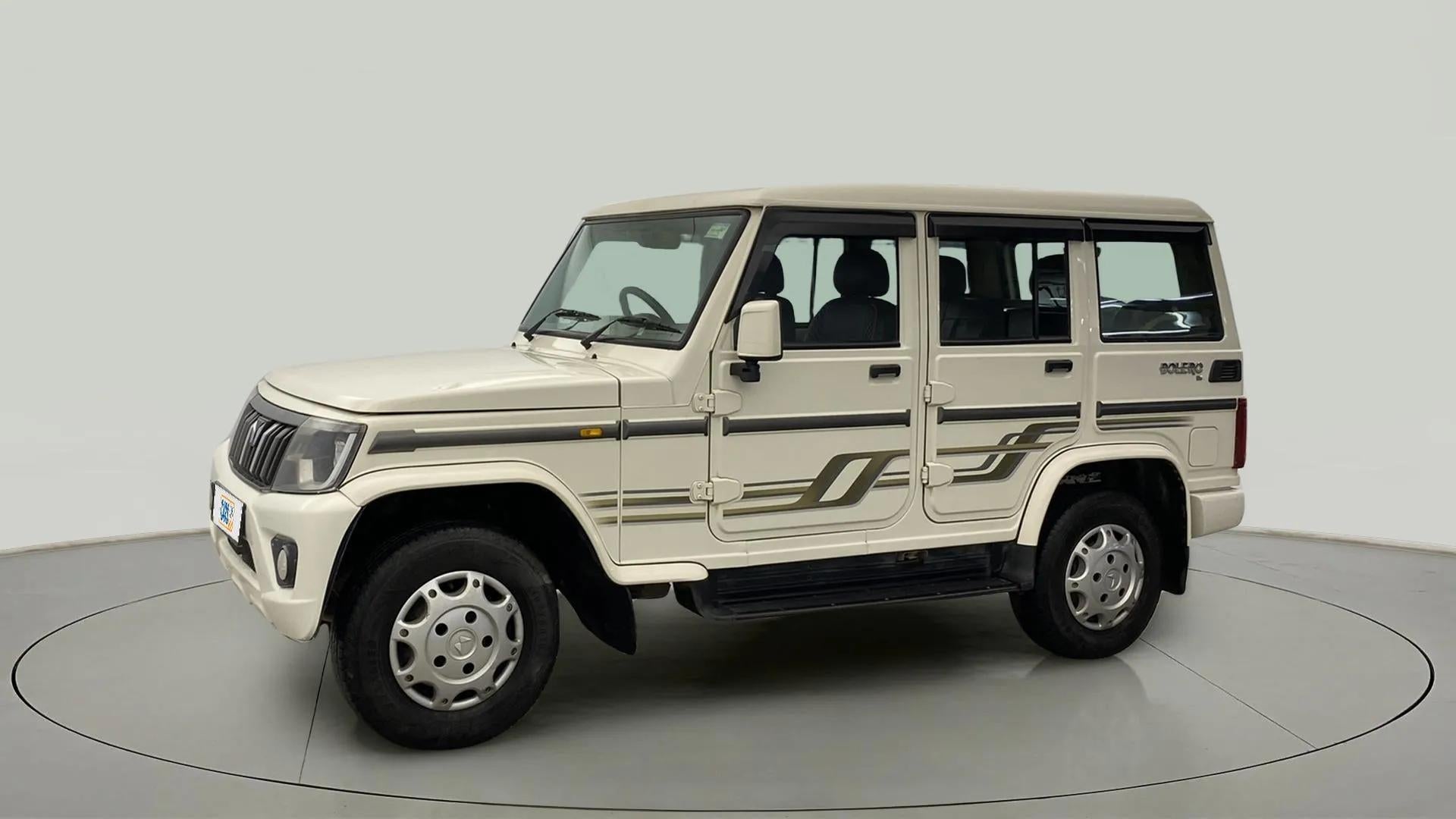 Side view of a diamond white Mahindra Bolero