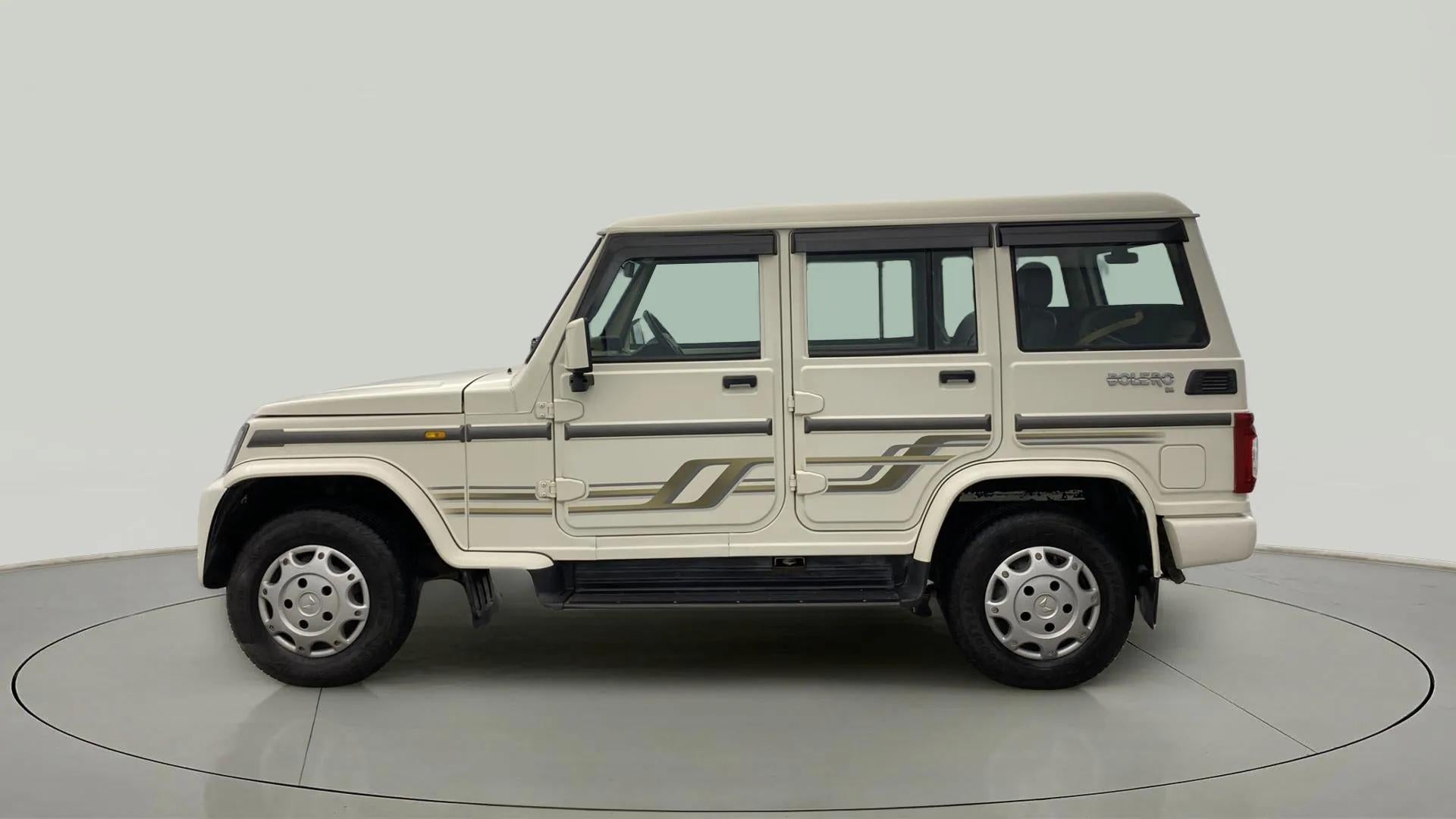 Side view of a diamond white Mahindra Bolero