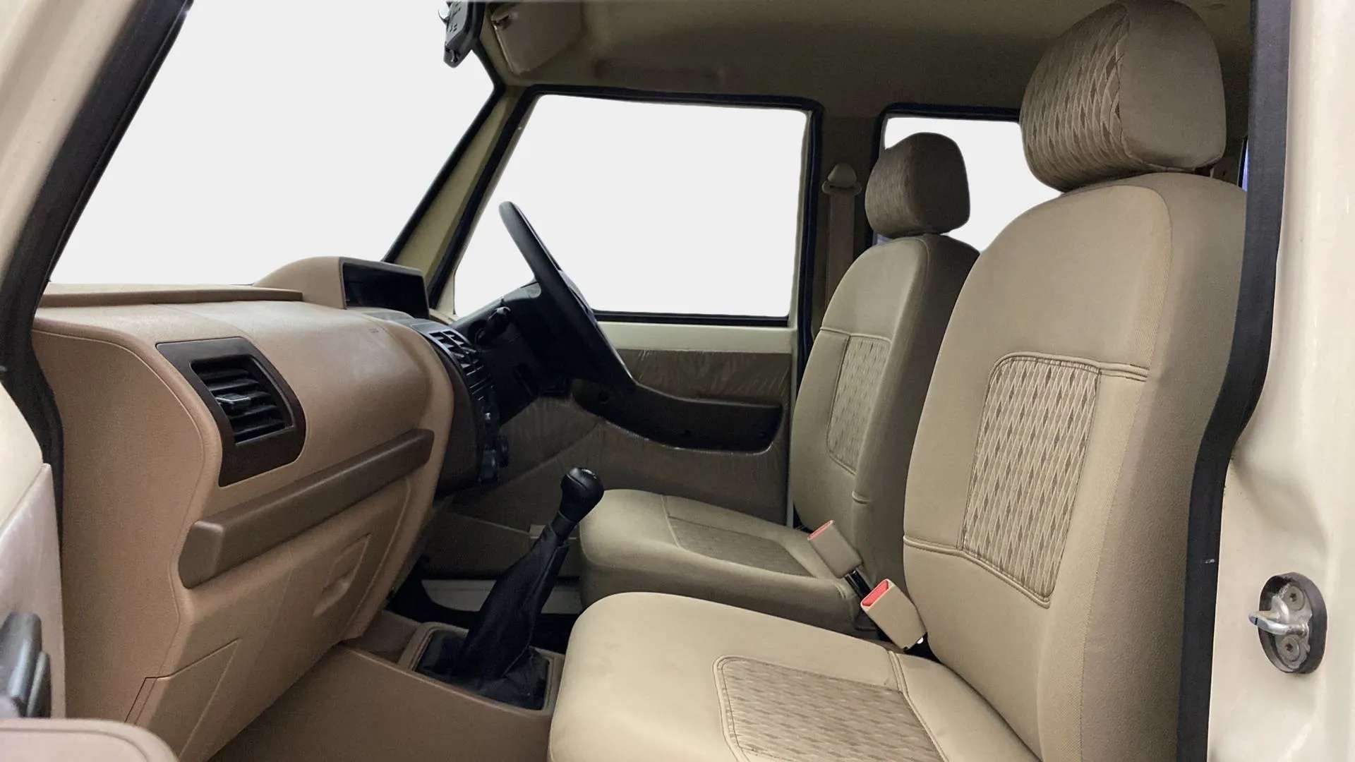 Interior front seats and dashboard of a Mahindra Bolero