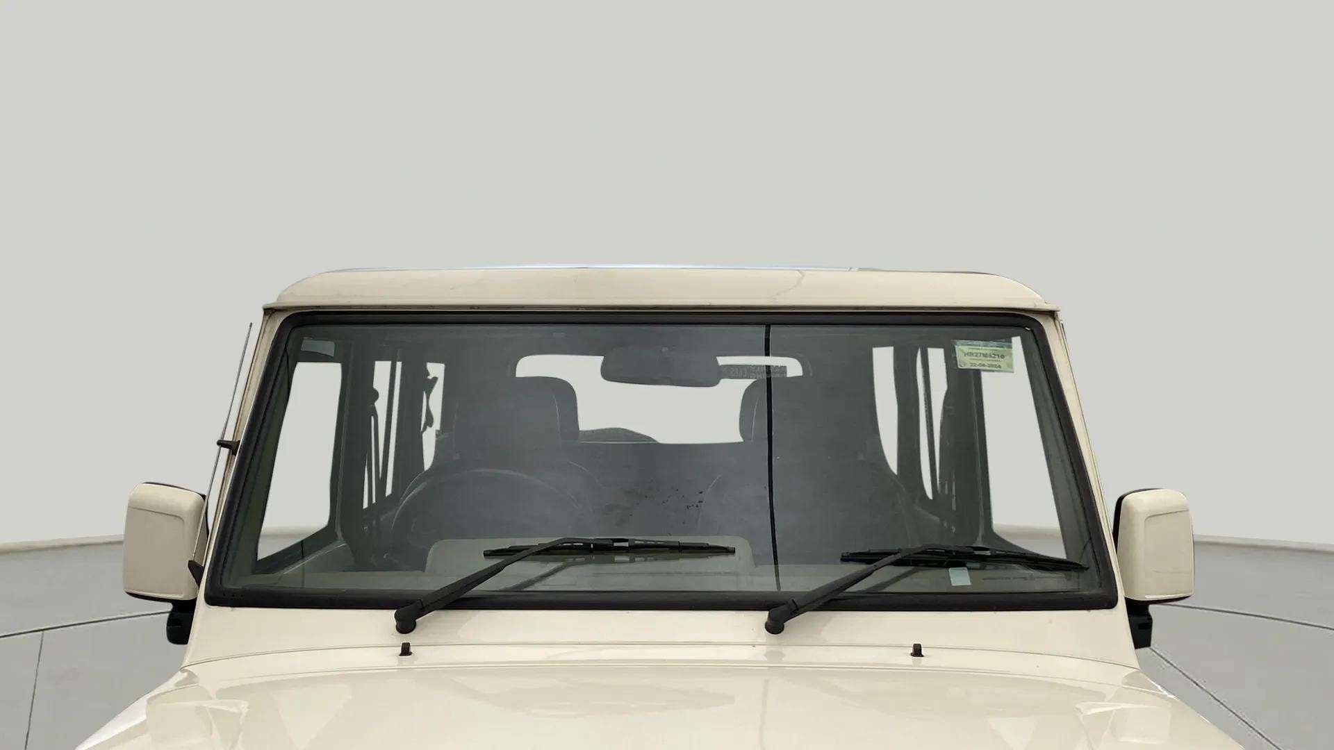 Front windshield view of a diamond white Mahindra Bolero