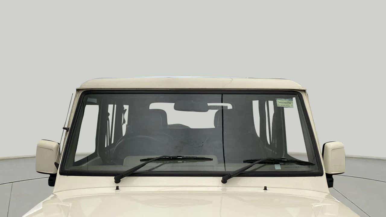 Front windshield view of a diamond white Mahindra Bolero