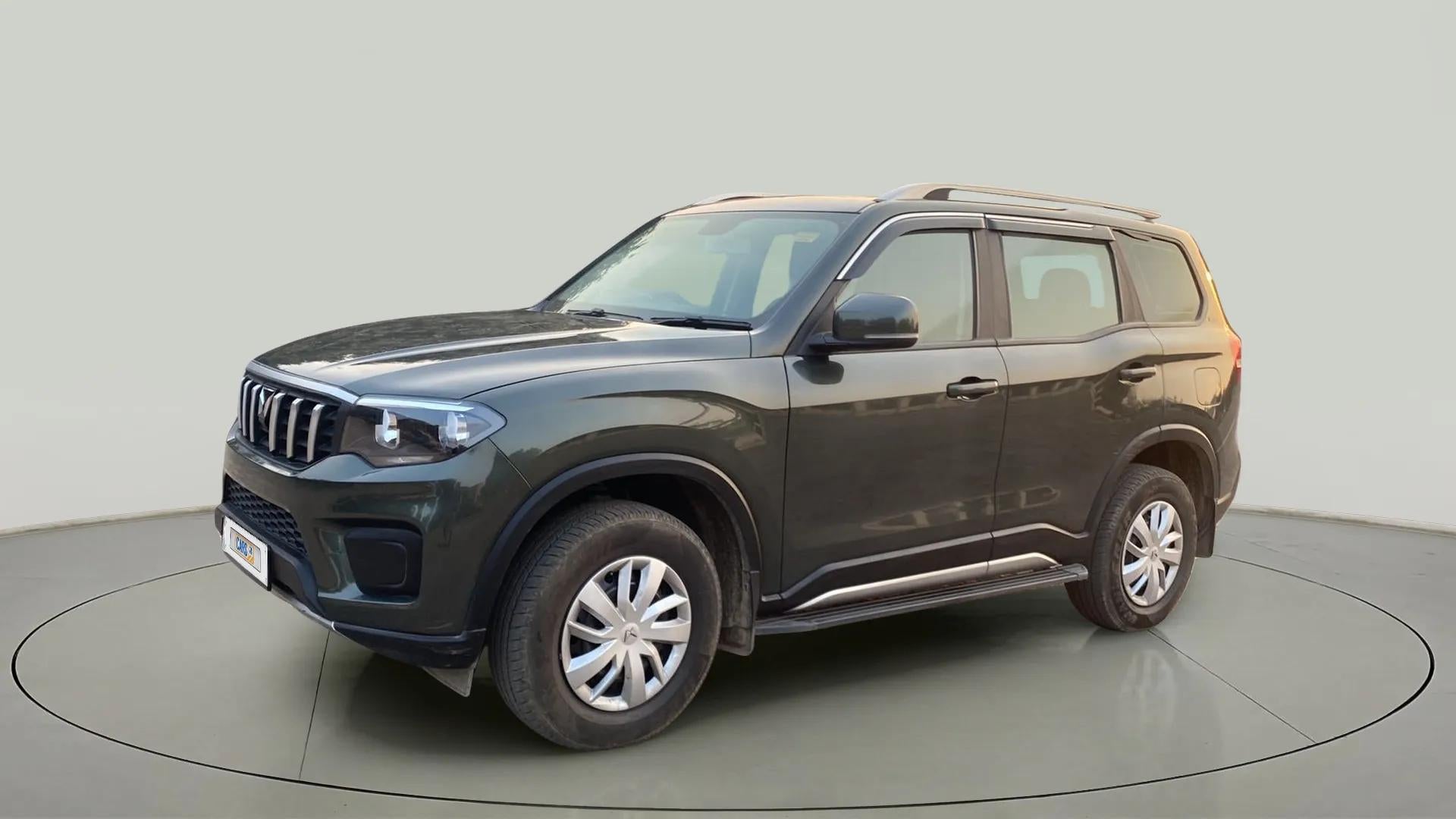 Front three-quarter of a deep forest Mahindra Scorpio-N