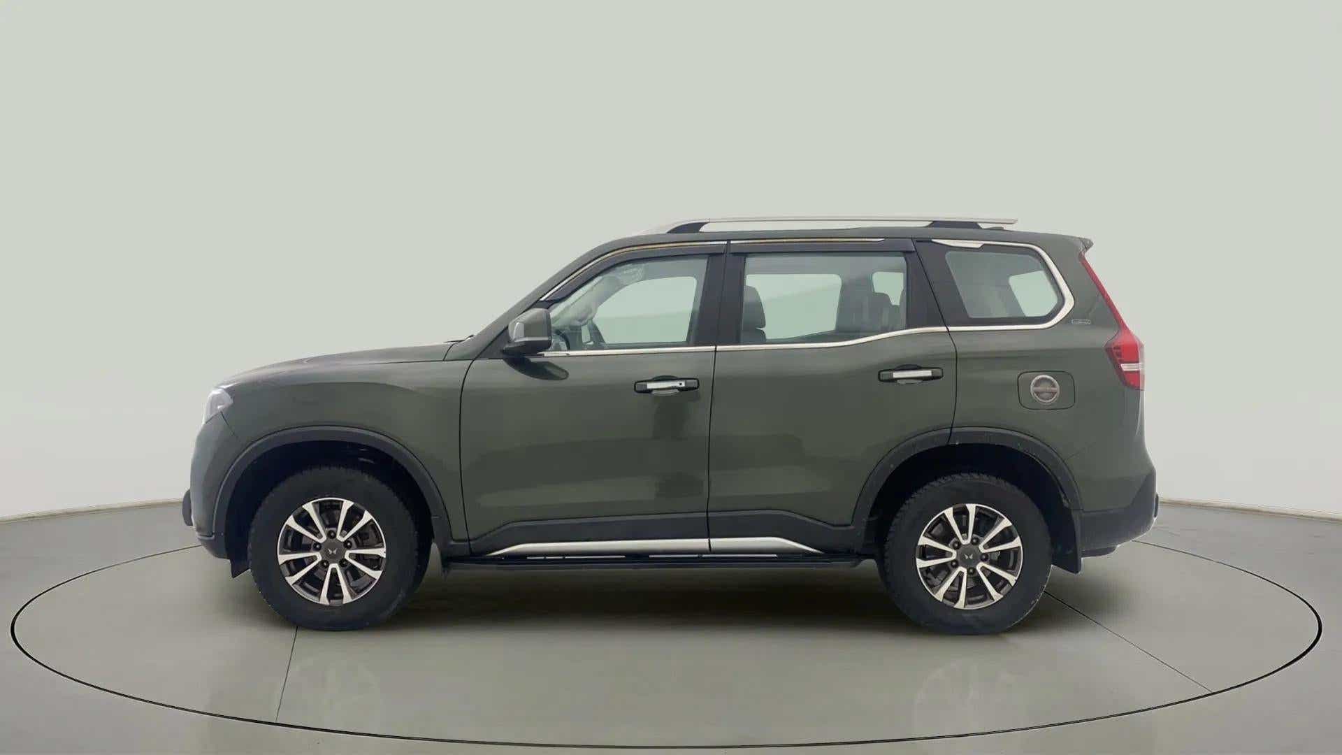 Side view of a deep forest Mahindra Scorpio-N