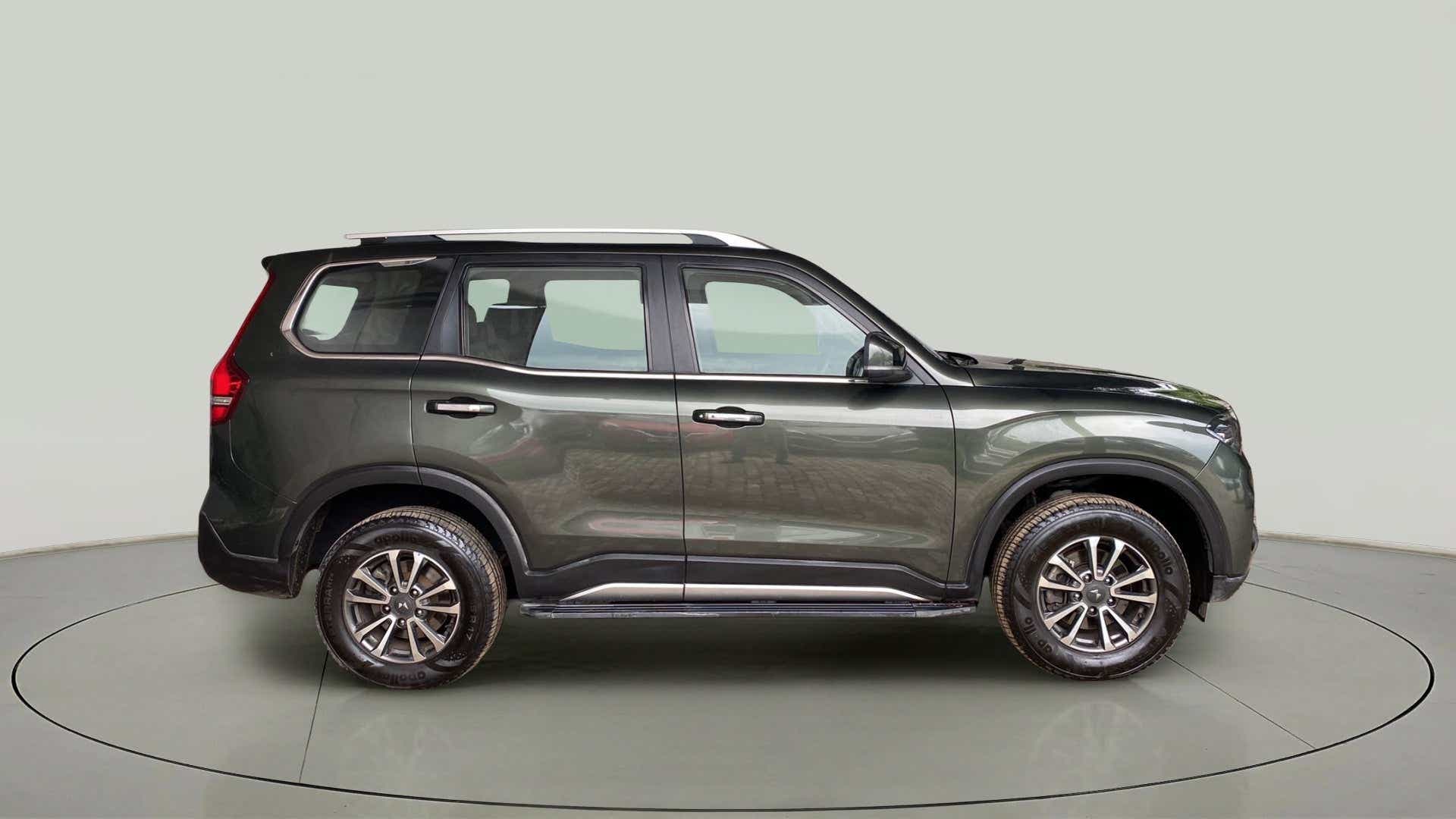 Side view of a deep forest Mahindra Scorpio-N